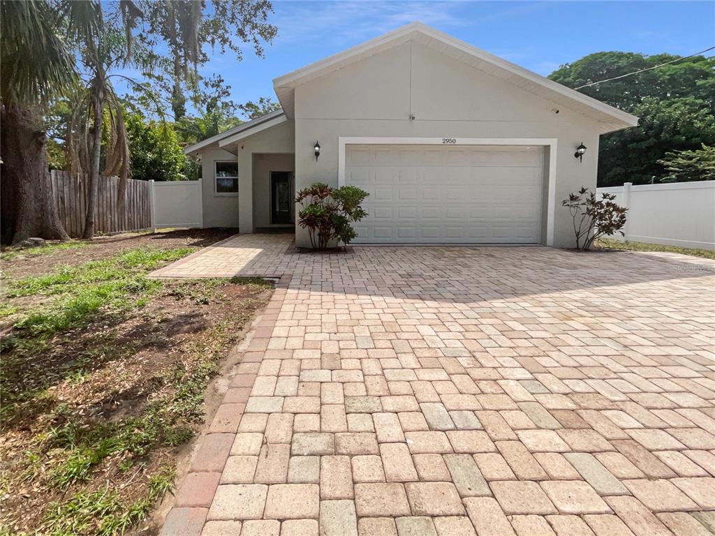 a front view of a house with a yard and a garage