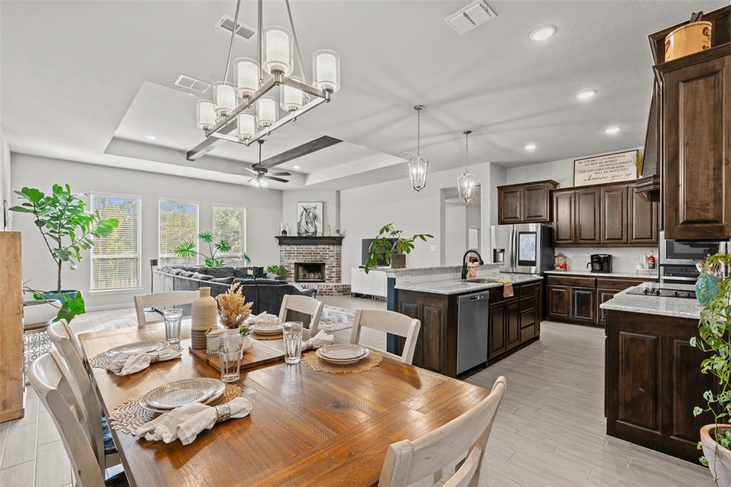 a living room with lots of furniture and kitchen view