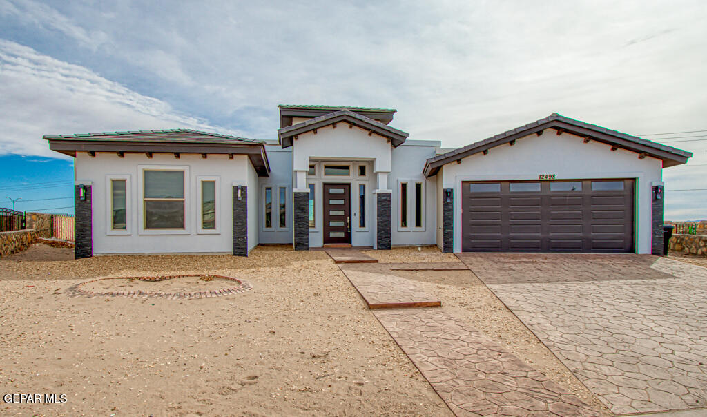 a front view of a house with a yard and garage