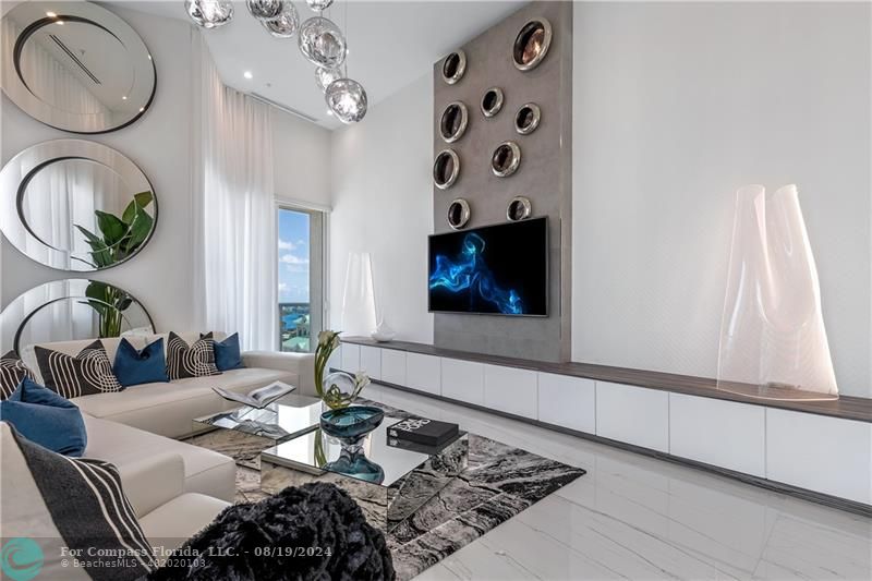 a living room with furniture a dining table and a fireplace