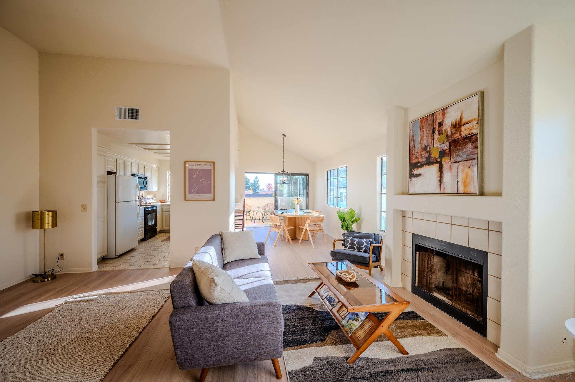 a living room with furniture a rug and a fireplace