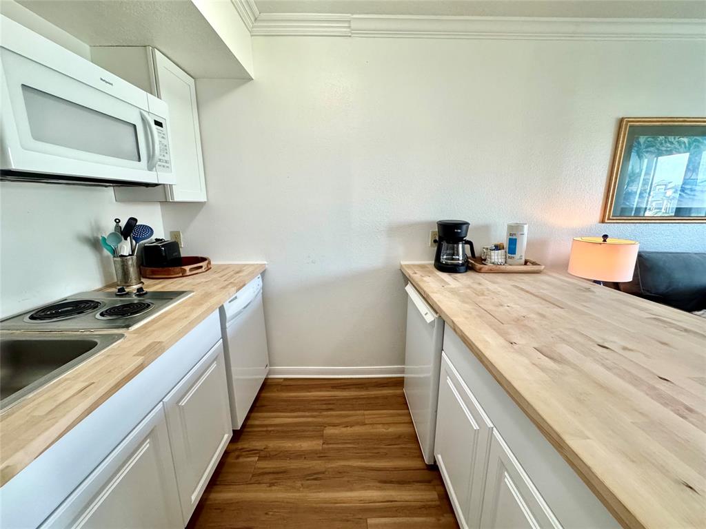 a kitchen with stainless steel appliances a sink and cabinets