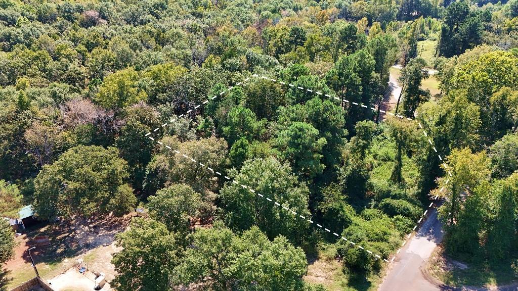 an aerial view of residential house with outdoor space and trees all around