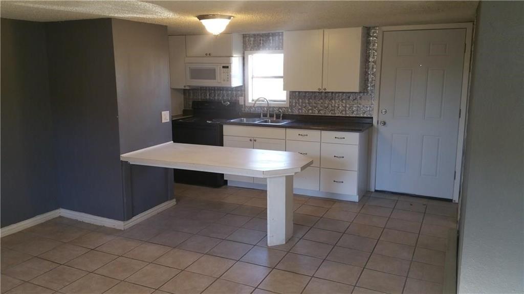 a kitchen with a sink cabinets and counter space