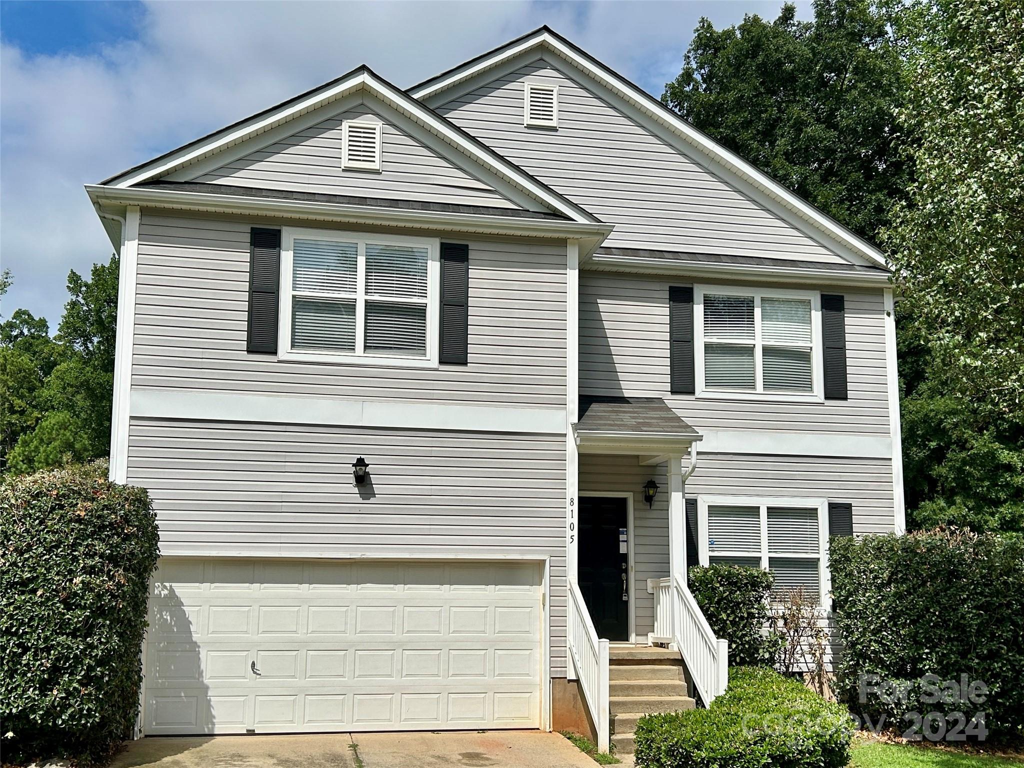 a front view of a house with garage