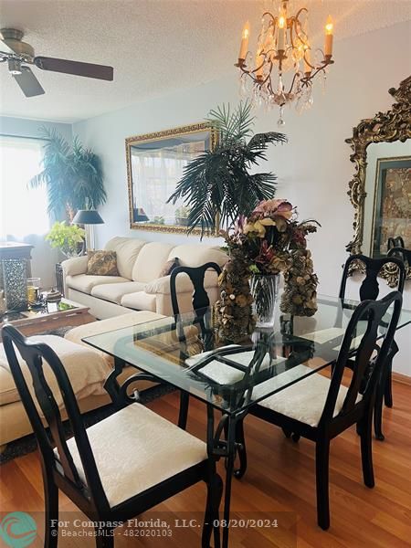 a view of a dining room with furniture and chandelier