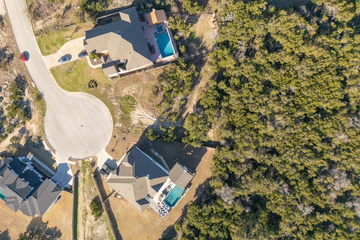 an aerial view of a house with a yard and fountain