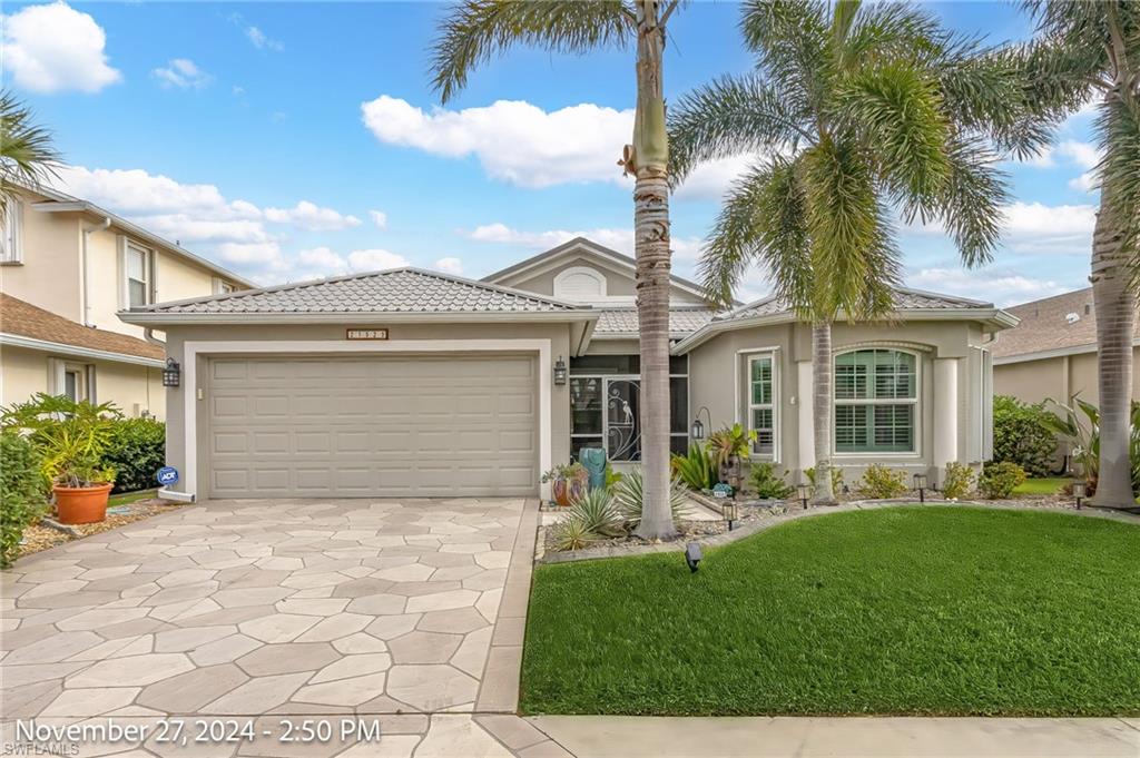 View of front of home with a garage and a front lawn