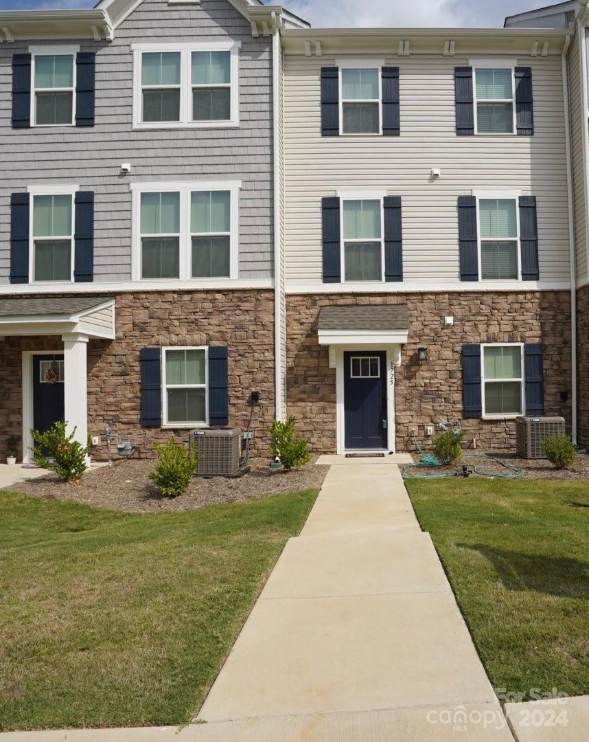 a front view of a brick house with a yard