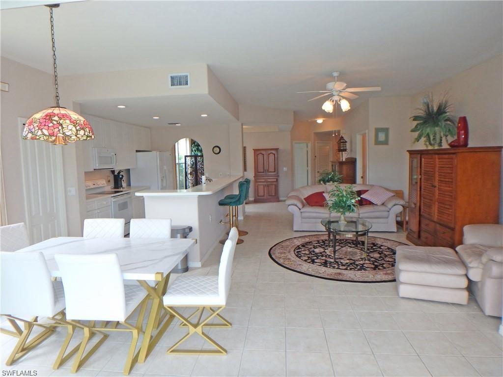 a dining room with furniture and a chandelier