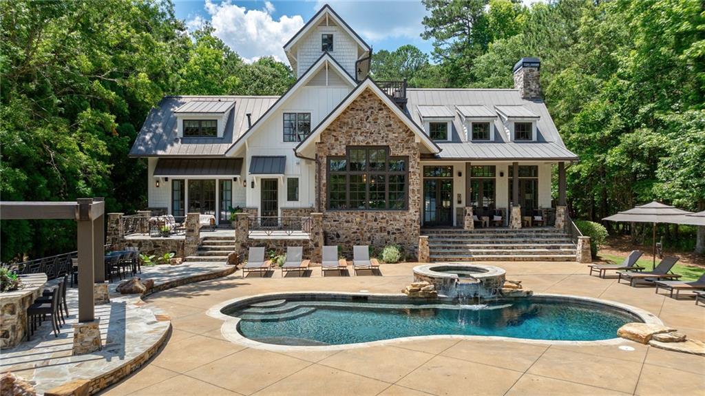 a front view of houses with yard patio and outdoor seating