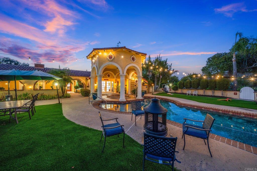 a view of swimming pool with outdoor seating and a garden