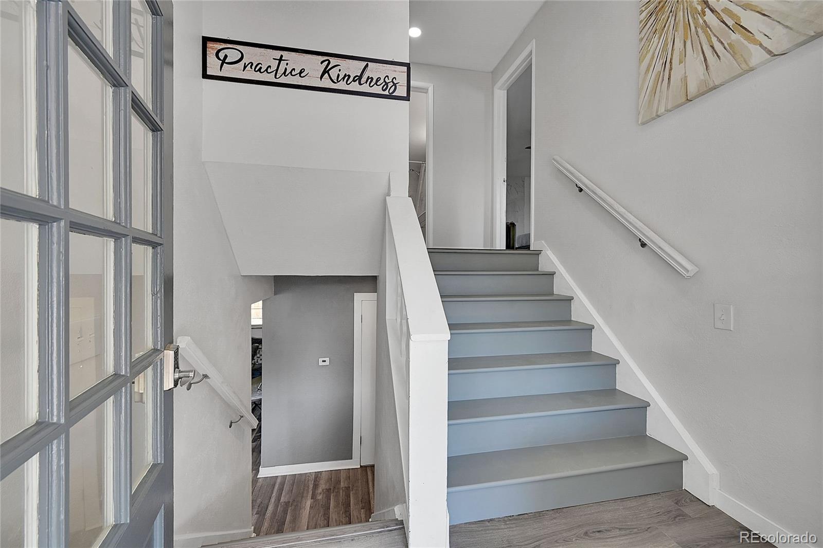 a view of staircase with white walls and a window