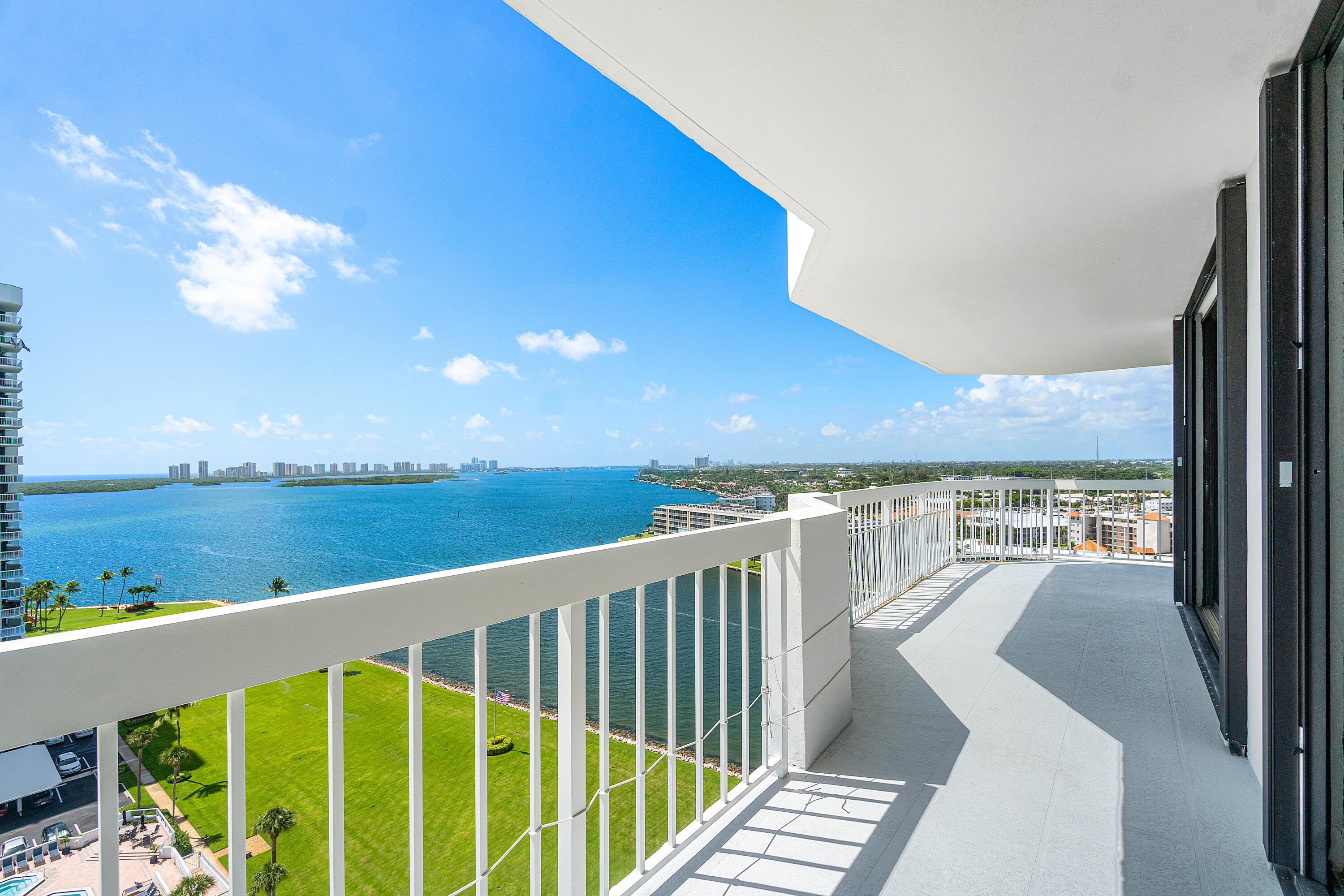 a view of a balcony with wooden floor and lake view