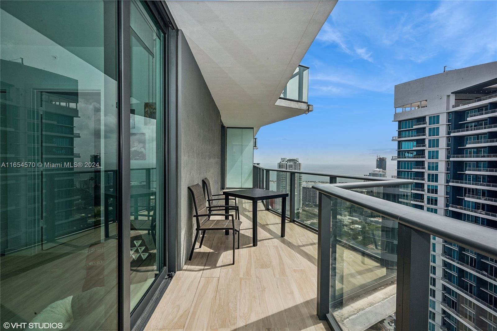 a balcony with table and chairs