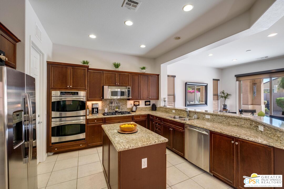 a kitchen with a sink and stainless steel appliances