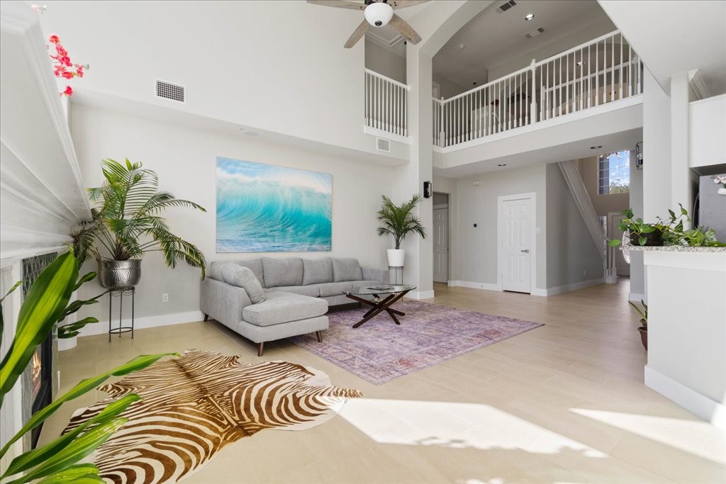 a living room with furniture windows and a potted plant