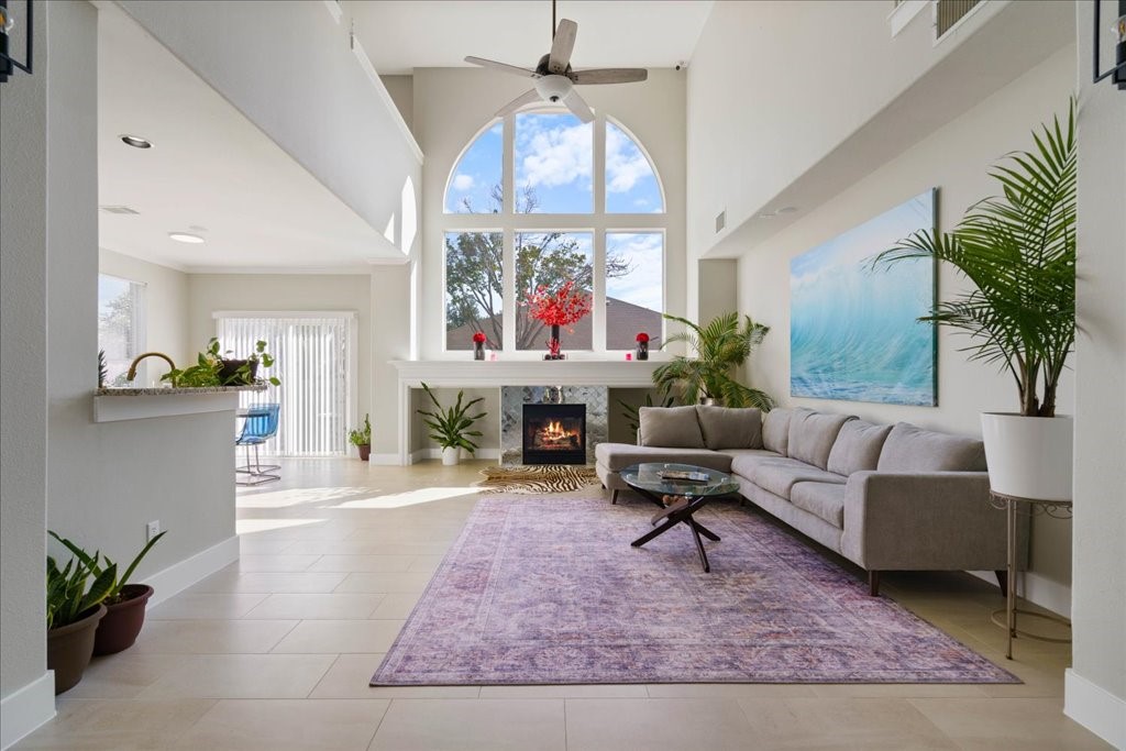 a living room with furniture a chandelier and a fireplace