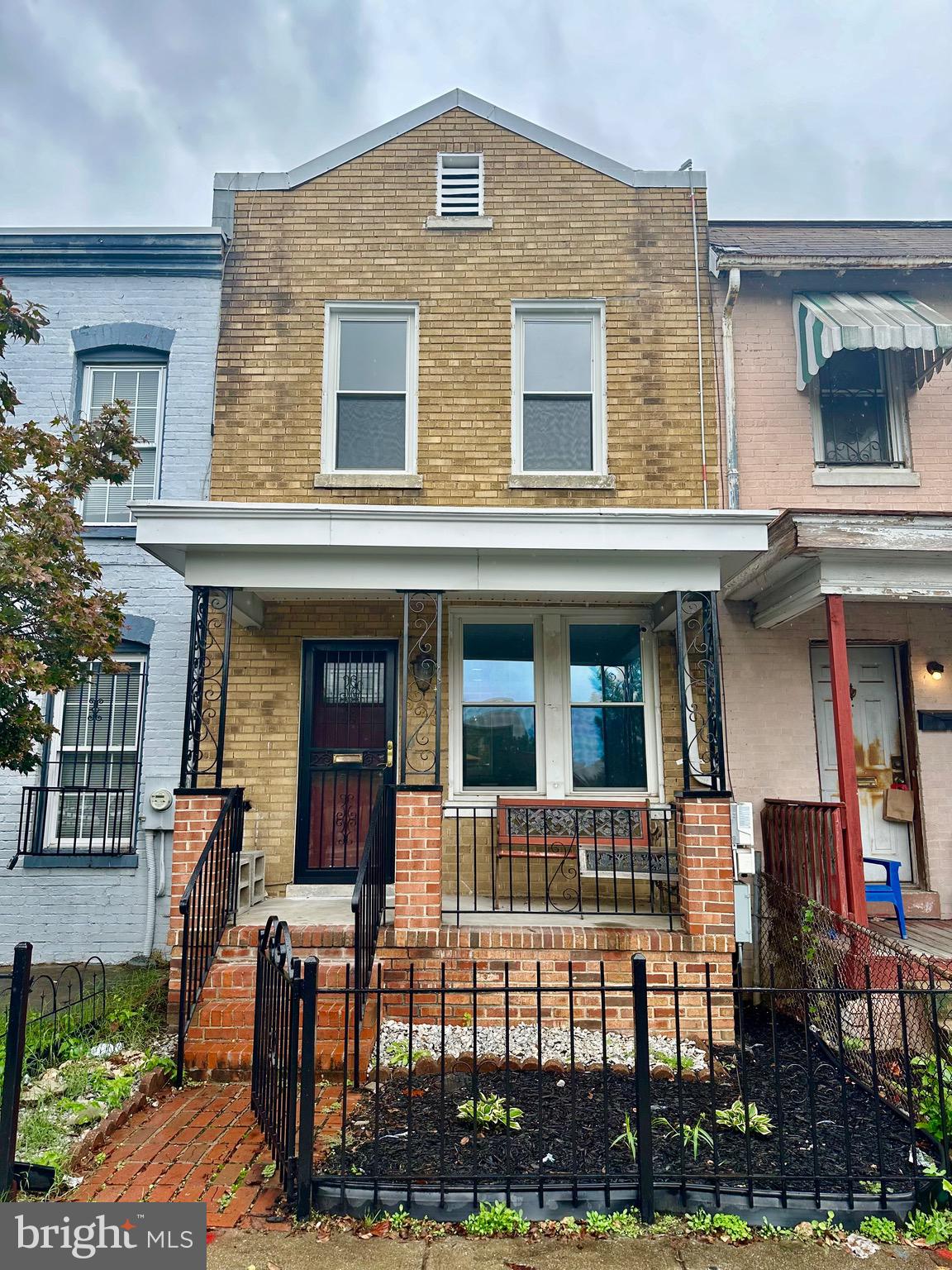 front view of a brick house with a porch