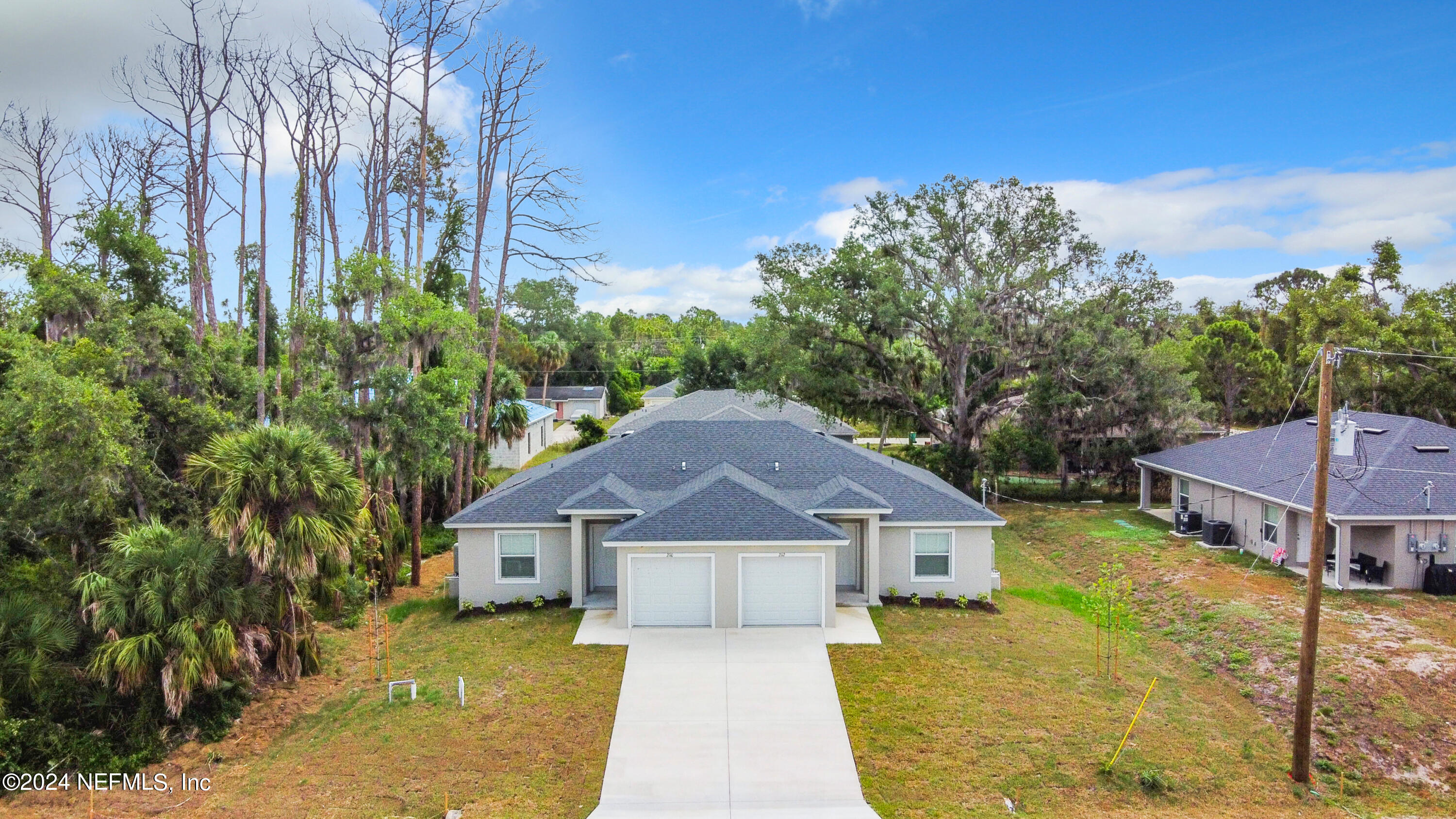 front view of a house next to a big yard