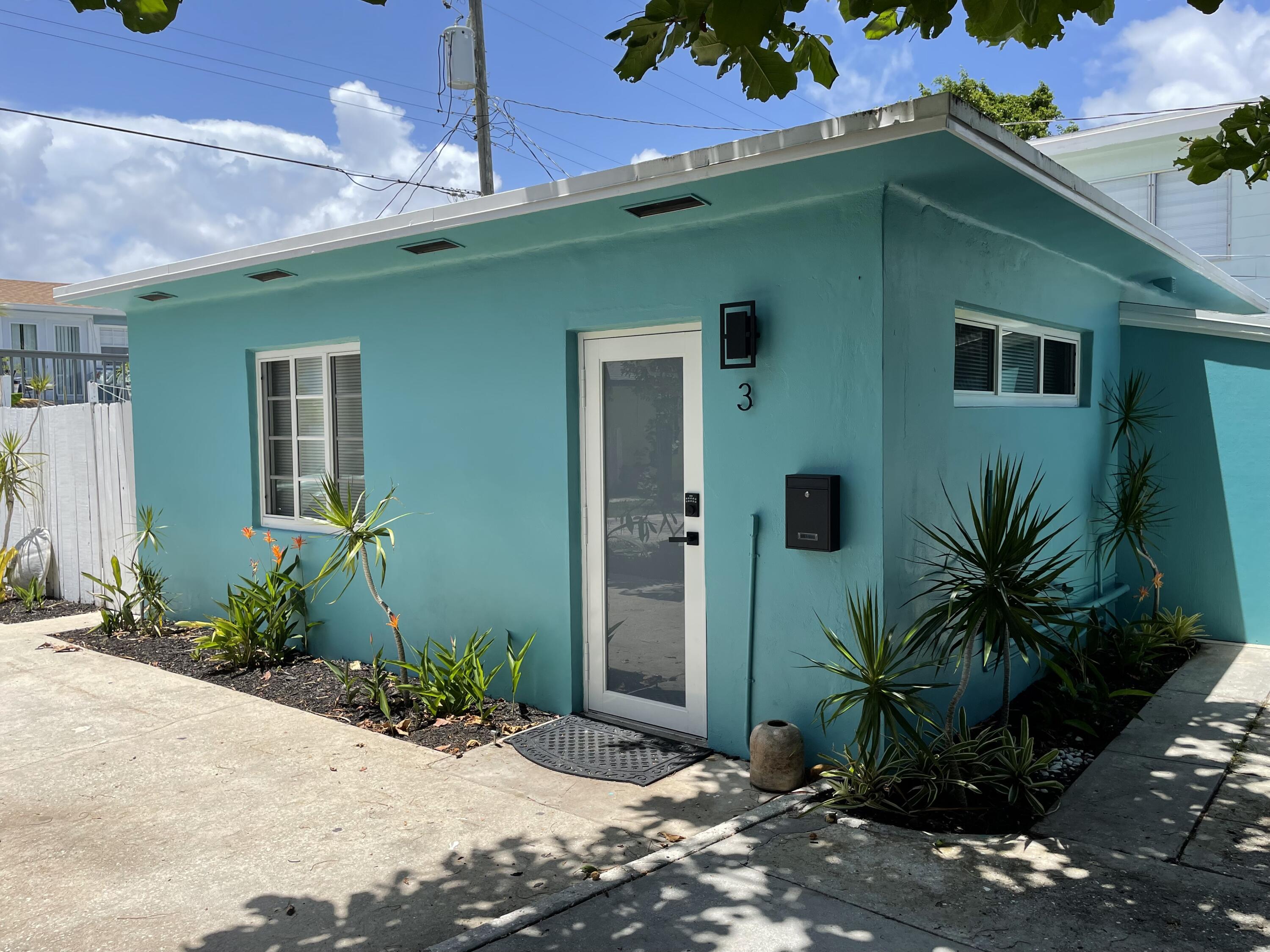 a front view of a house with plants