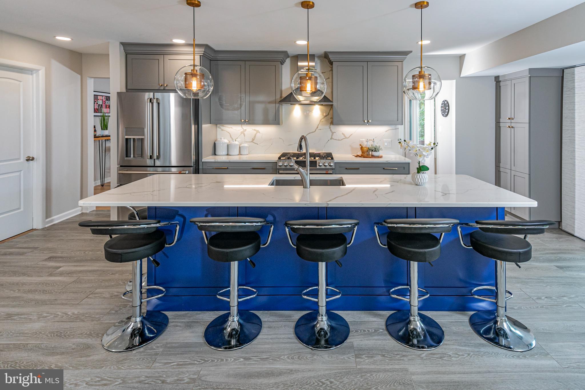 a kitchen with cabinets and wooden floor