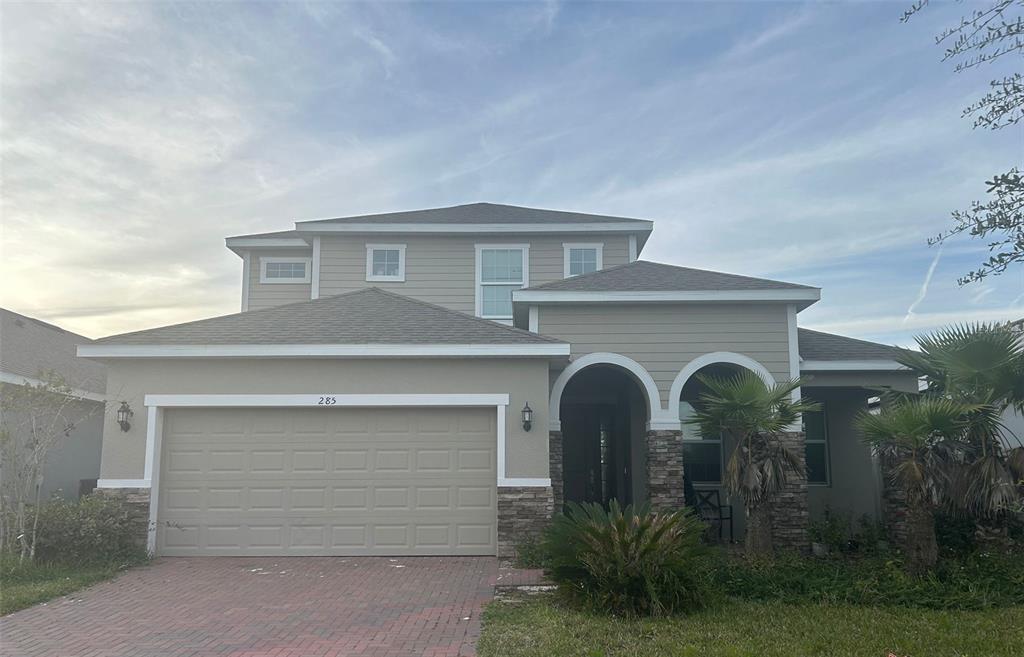 a front view of a house with garage