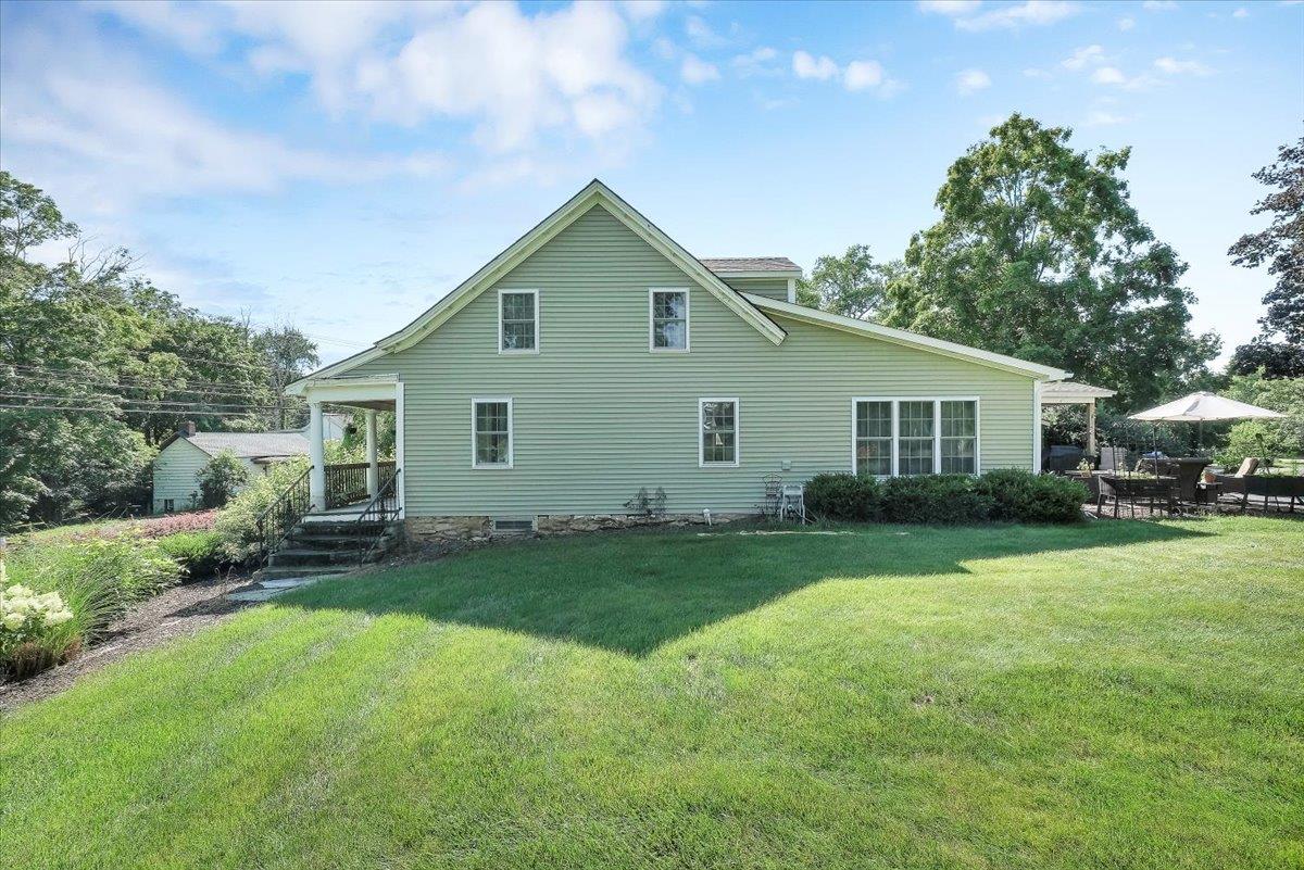 Back of house with a lawn