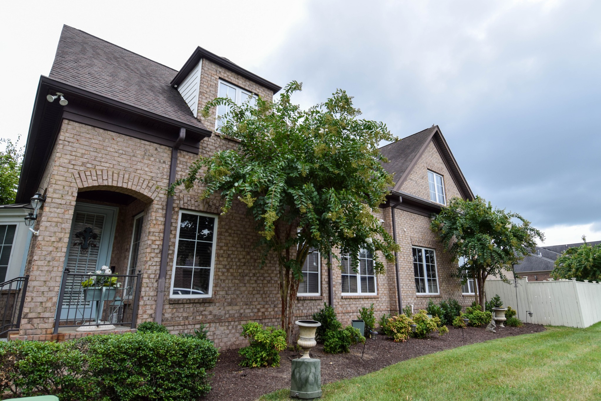 a front view of a house with garden