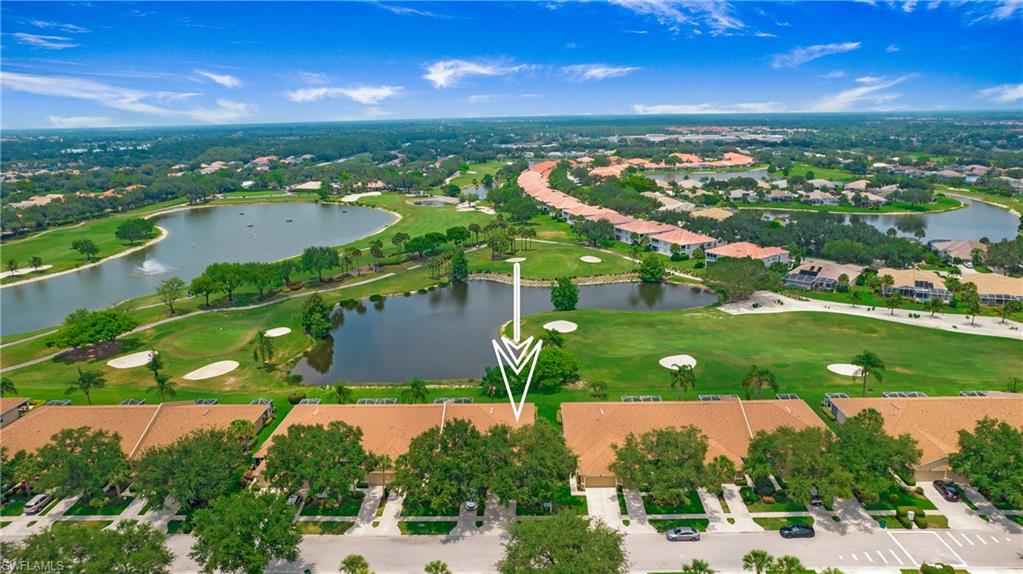 Birds eye view of property with a water view