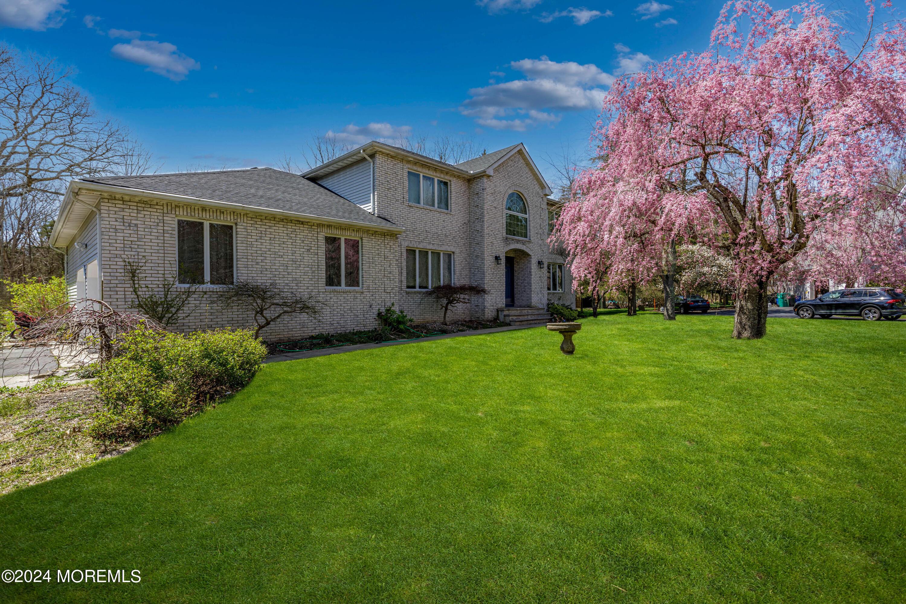 a front view of house with yard and green space