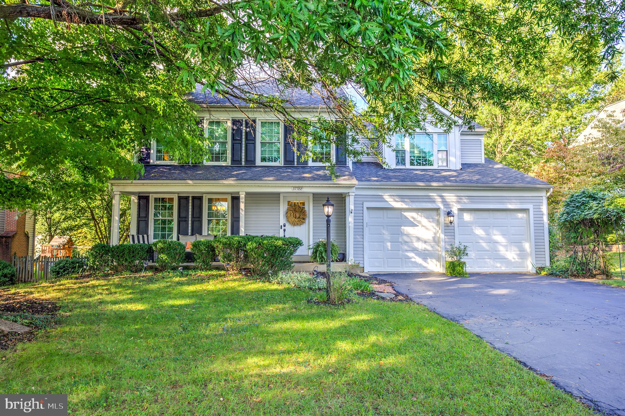 a front view of a house with a yard and porch