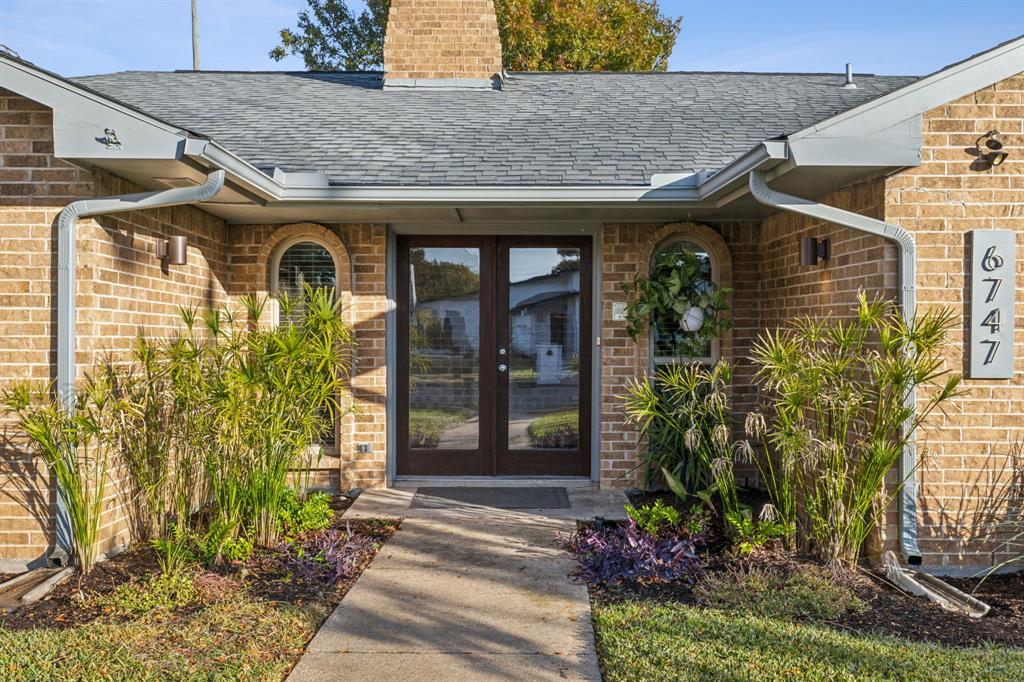 a view of a house with potted plants