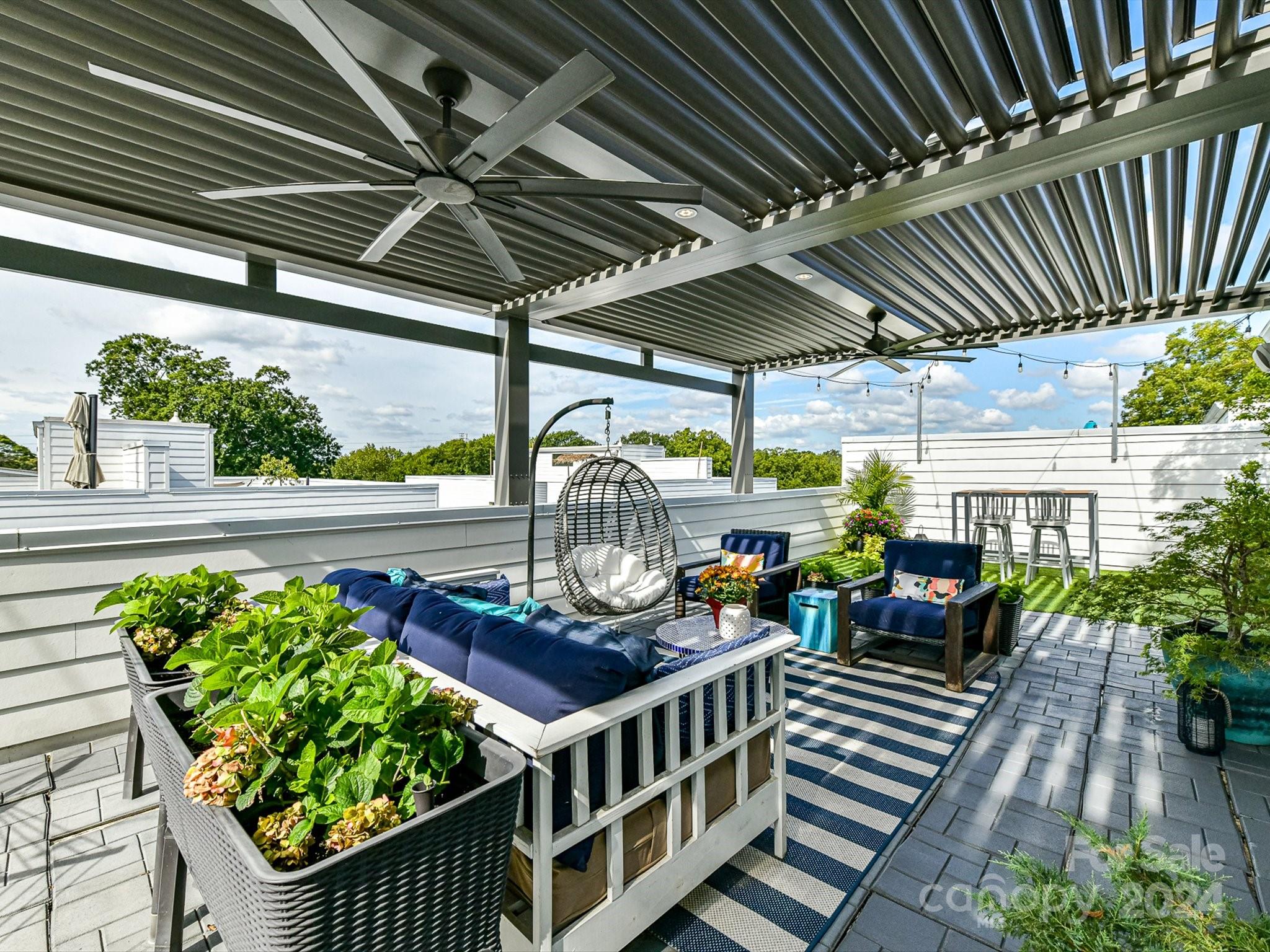 a view of a chairs and table in patio with wooden fence