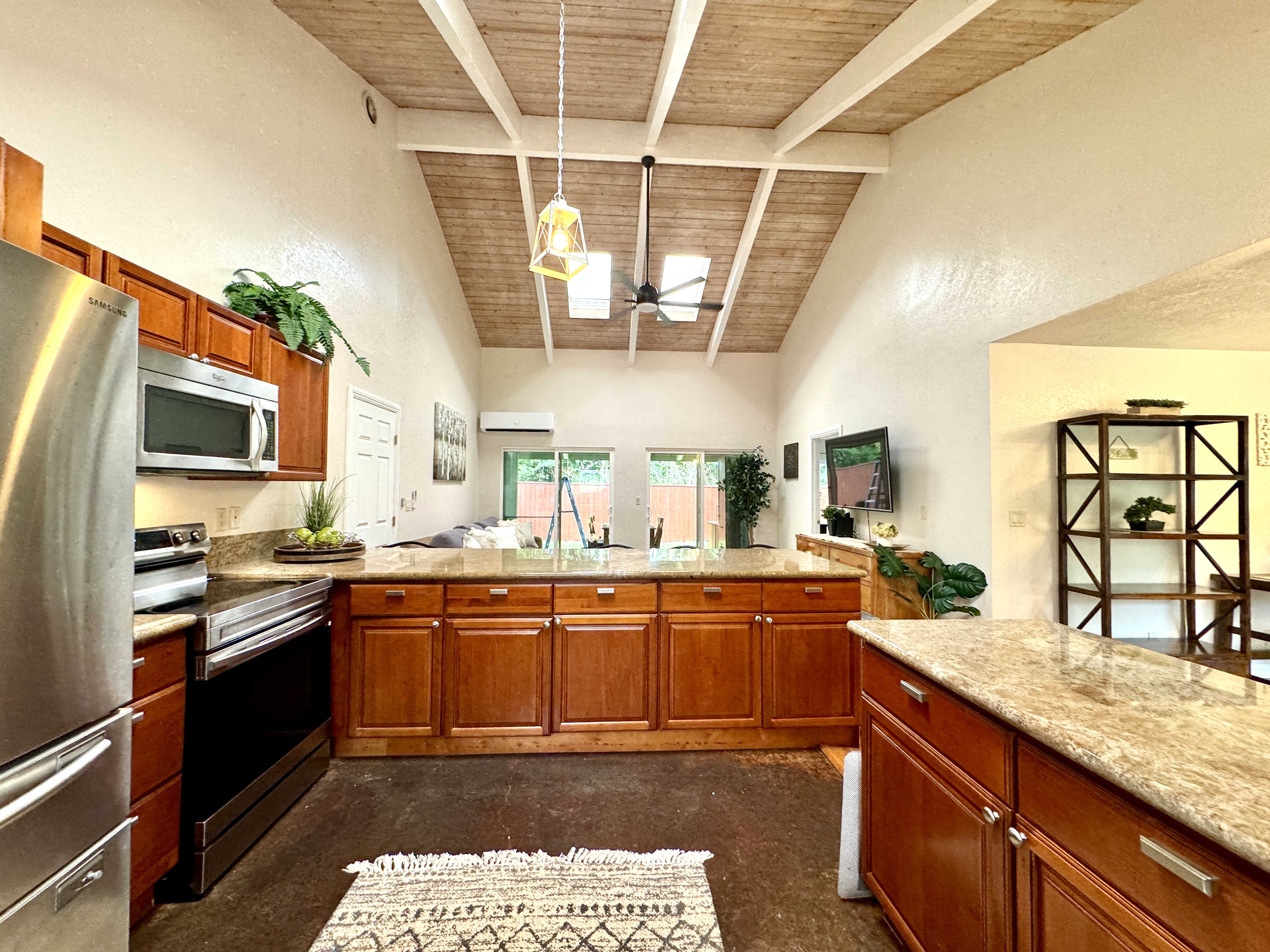 Wonderful view of the open bean vaulted wood ceilings with skylights in living and kitchen areas..