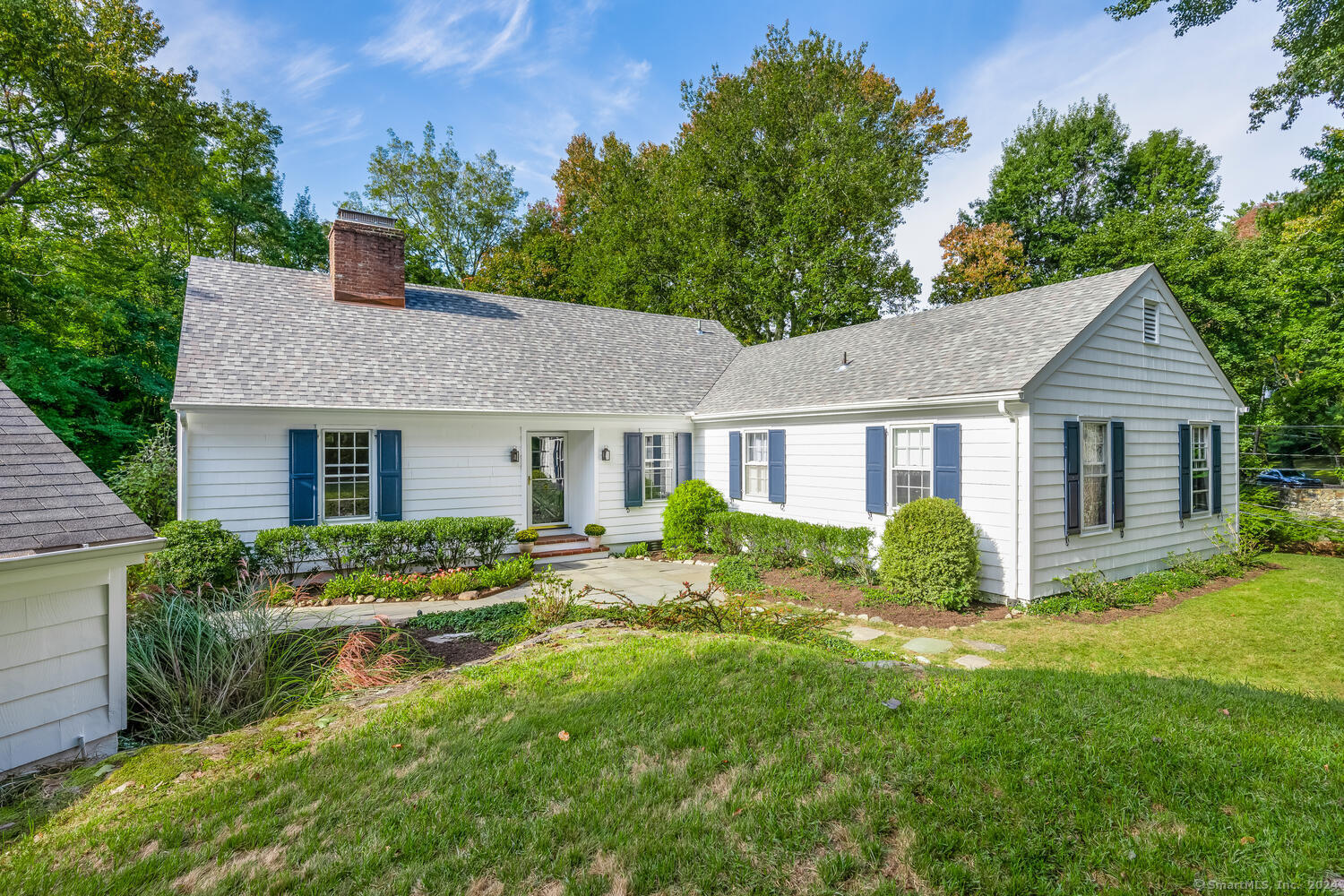 a front view of house with yard and green space