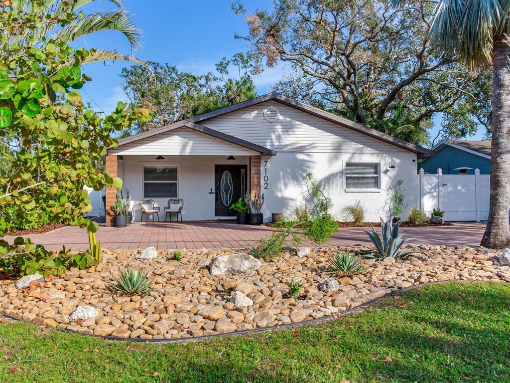 a front view of a house with garden