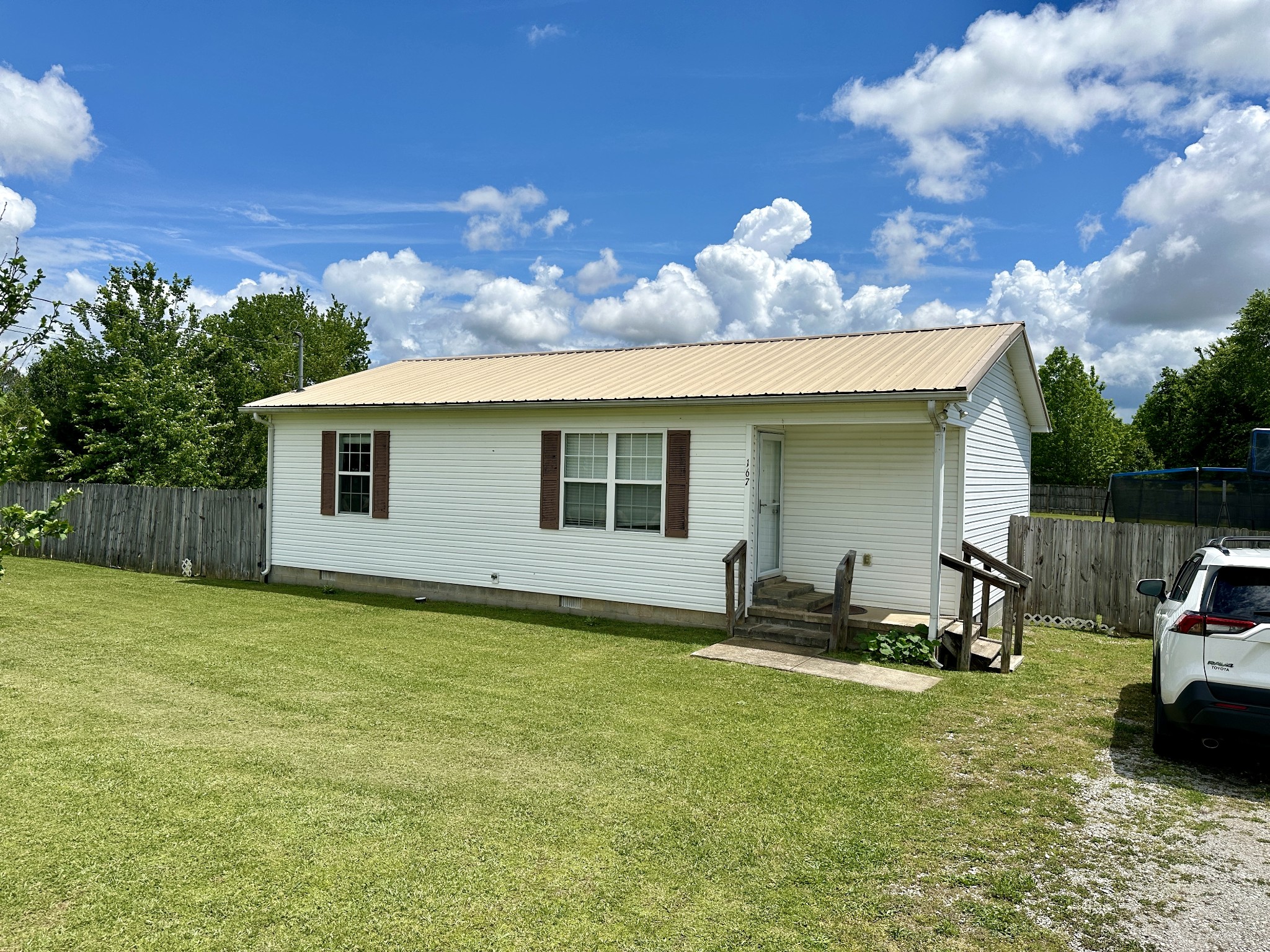 a view of a house with backyard and sitting area