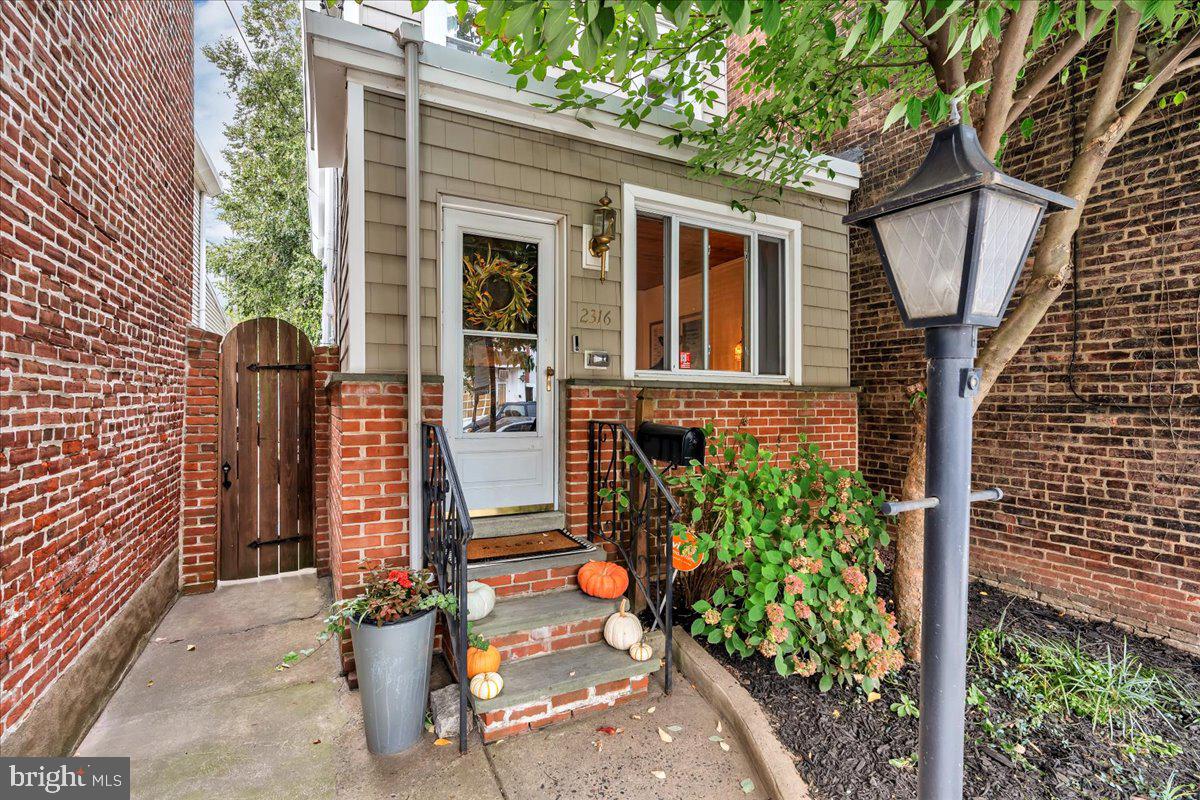 a view of a house with brick walls