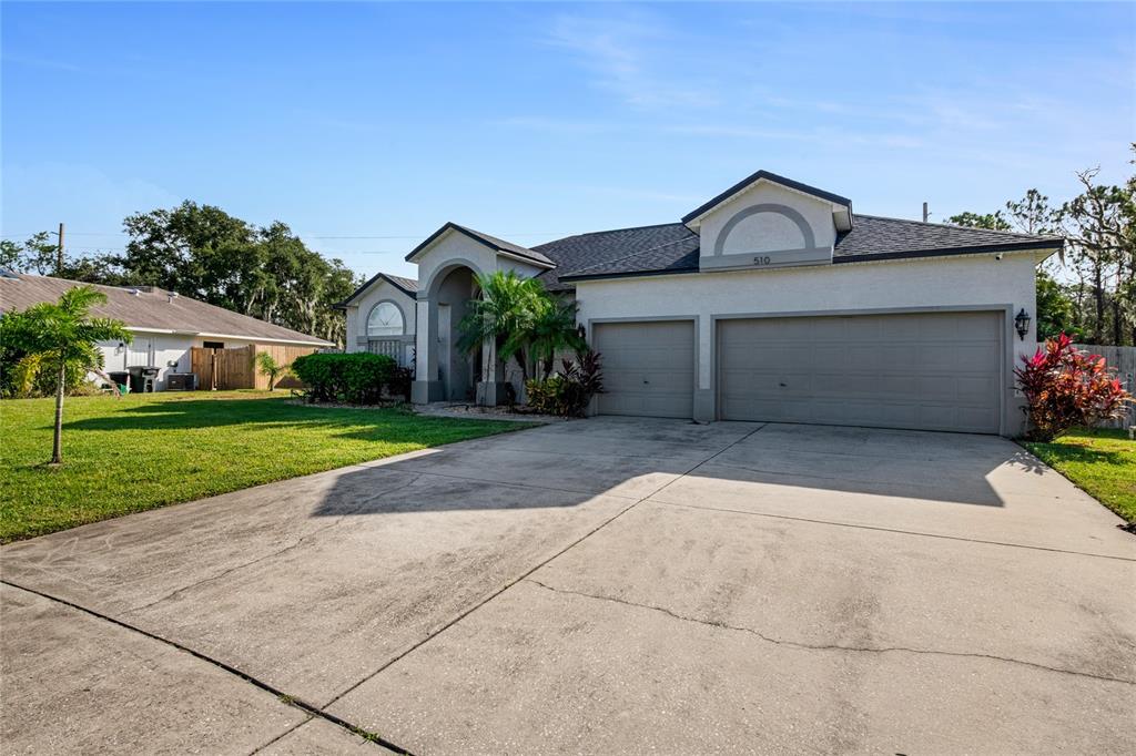 a front view of a house with a yard and garage