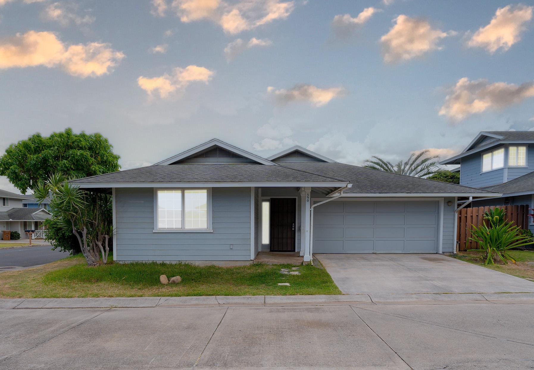 a front view of a house with a yard and garage