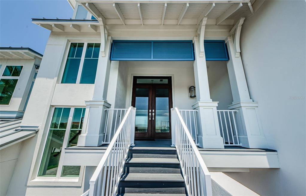 a view of staircase with white walls and a window