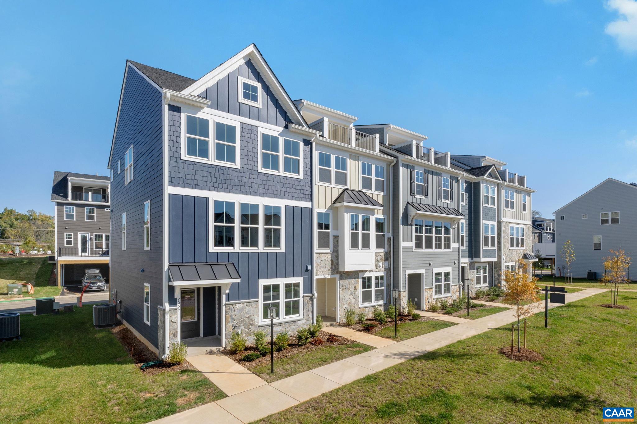 a front view of a residential apartment building with a yard