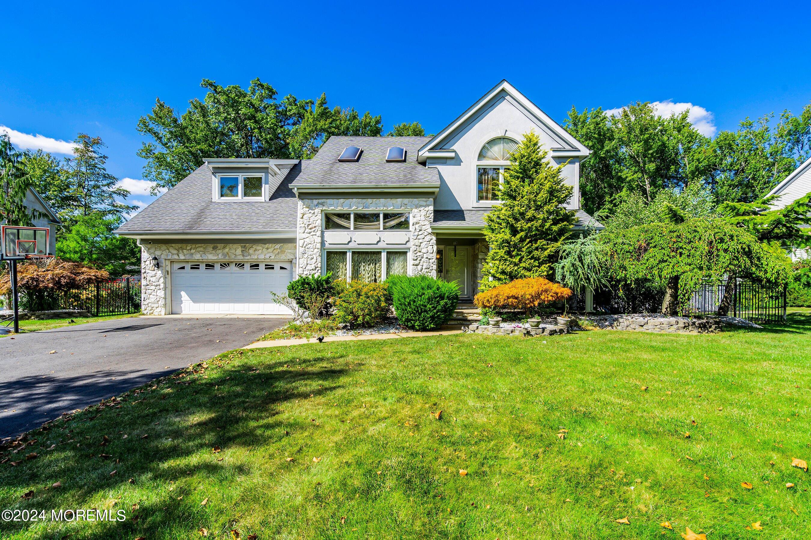 a front view of house with yard and green space