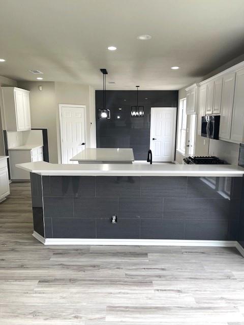 a view of kitchen with granite countertop cabinets and wooden floor