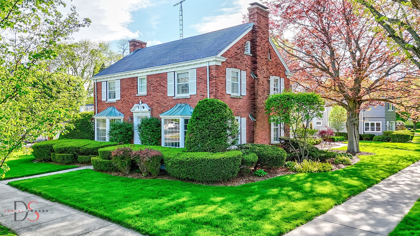 a view of a house with a yard and plants