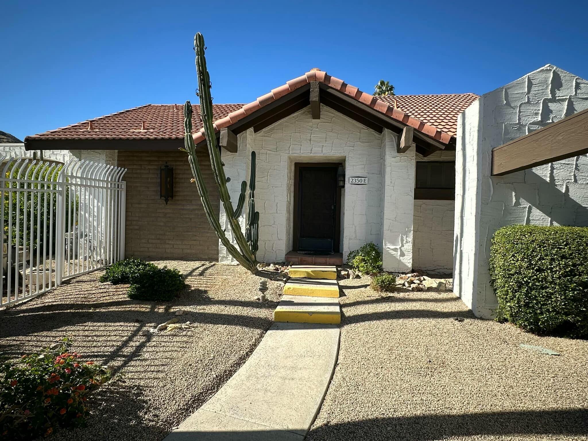 a front view of a house with small garden