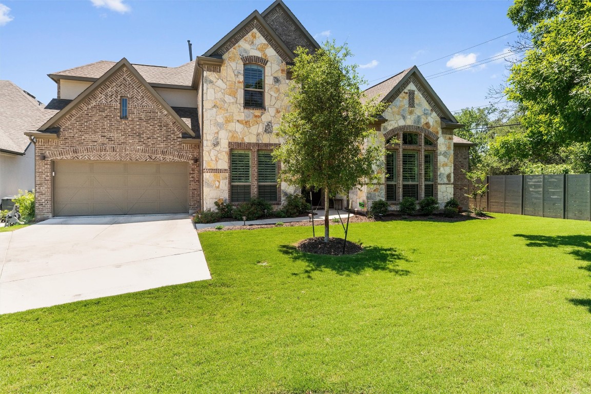 a front view of house with yard and green space