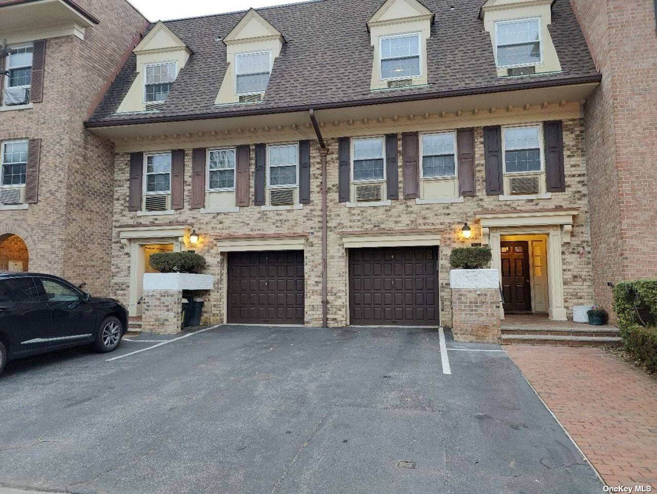 a view of building with car parked