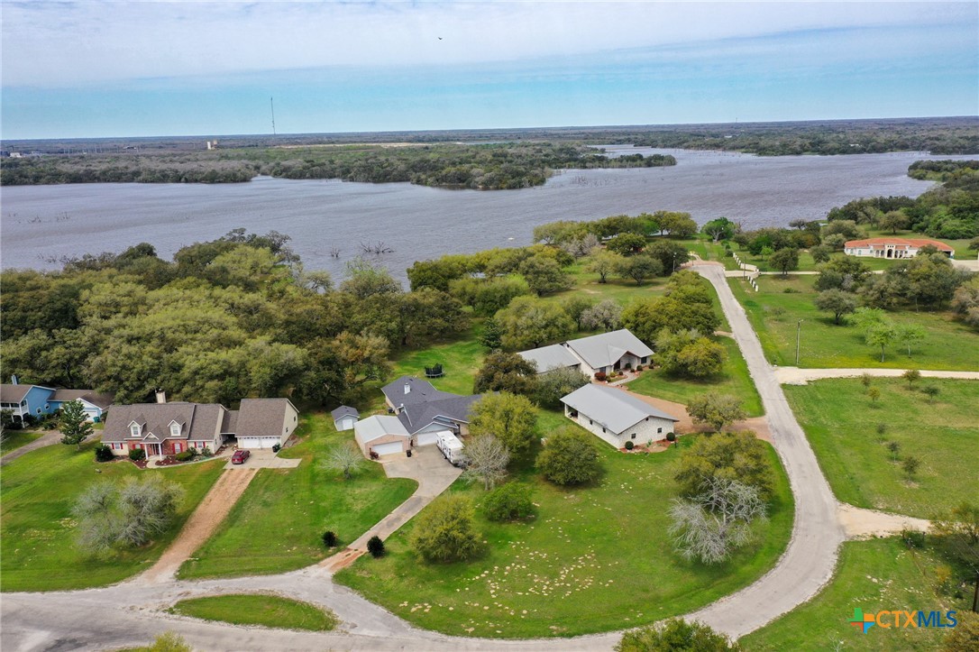 an aerial view of a house with outdoor space and lake view